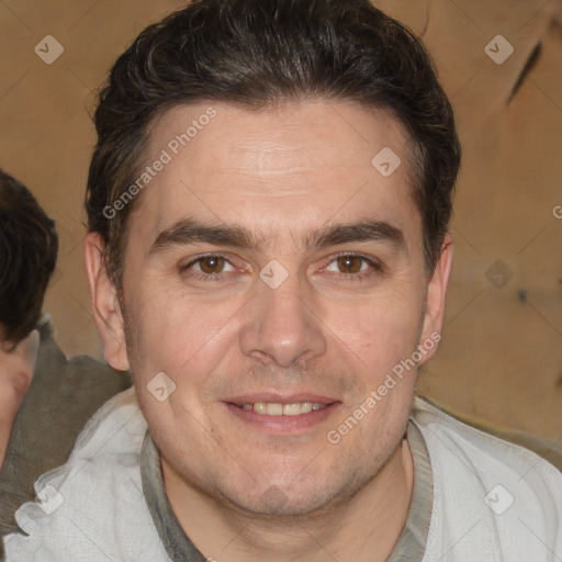 Joyful white adult male with short  brown hair and brown eyes