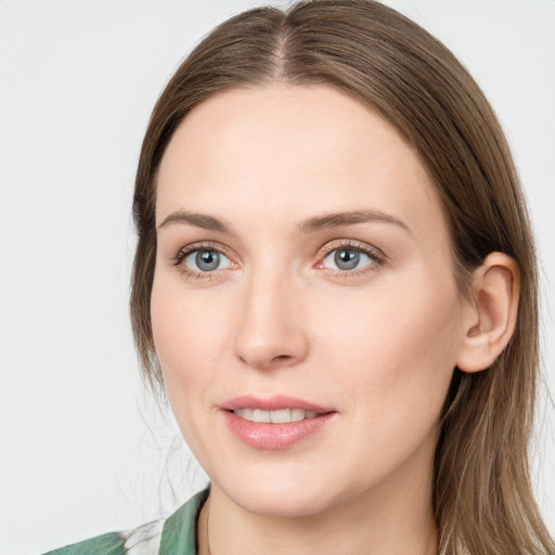 Joyful white young-adult female with long  brown hair and green eyes