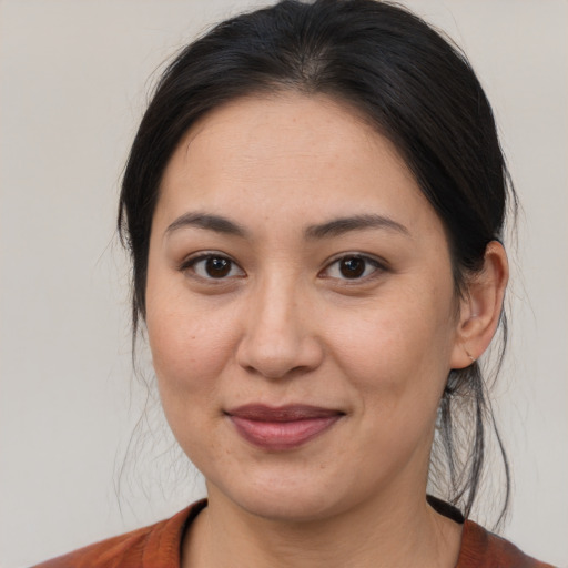 Joyful latino young-adult female with medium  brown hair and brown eyes