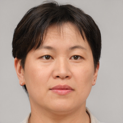 Neutral asian adult female with short  brown hair and brown eyes