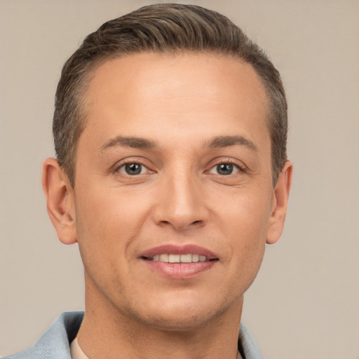 Joyful white adult male with short  brown hair and brown eyes