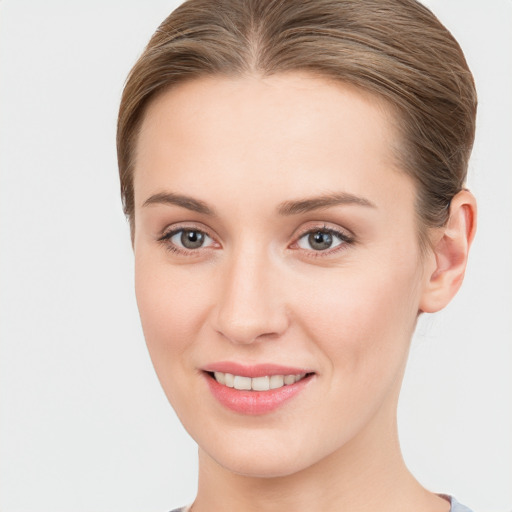 Joyful white young-adult female with long  brown hair and grey eyes