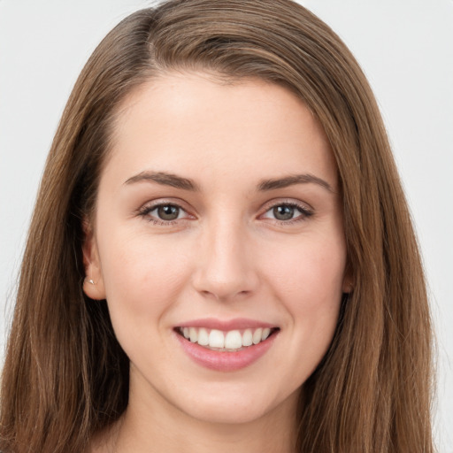 Joyful white young-adult female with long  brown hair and brown eyes