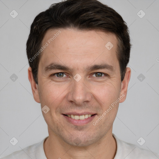 Joyful white adult male with short  brown hair and grey eyes