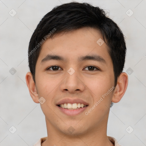 Joyful asian young-adult male with short  brown hair and brown eyes