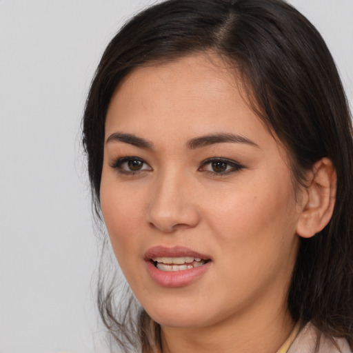 Joyful asian young-adult female with medium  brown hair and brown eyes