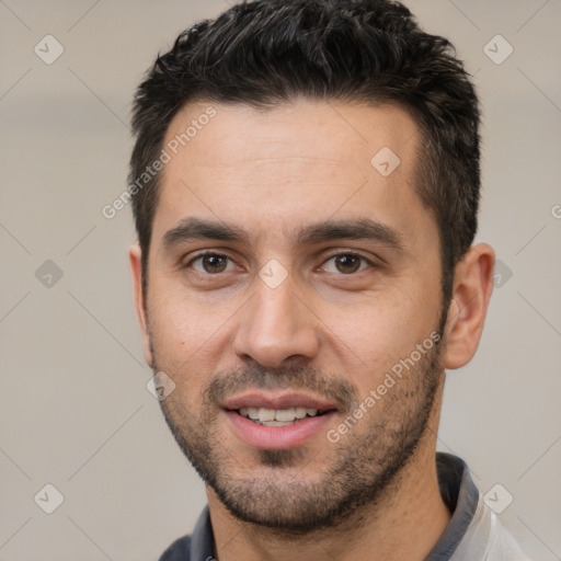 Joyful white young-adult male with short  black hair and brown eyes