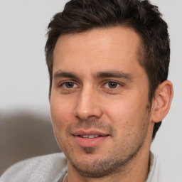 Joyful white adult male with short  brown hair and brown eyes