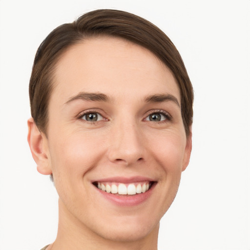 Joyful white young-adult female with short  brown hair and grey eyes