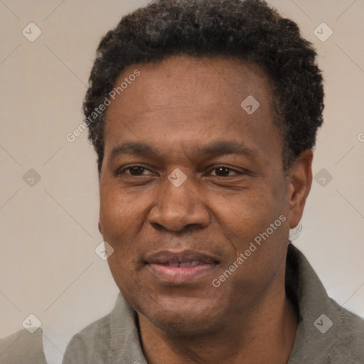 Joyful black adult male with short  black hair and brown eyes