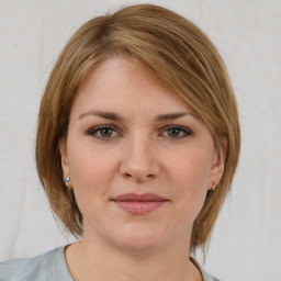 Joyful white young-adult female with medium  brown hair and grey eyes