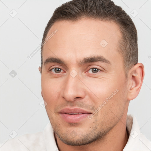 Joyful white young-adult male with short  brown hair and brown eyes