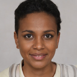 Joyful black young-adult female with short  brown hair and brown eyes