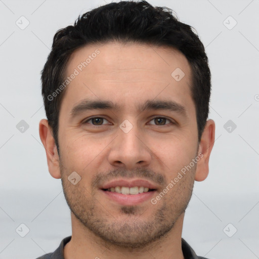 Joyful white young-adult male with short  black hair and brown eyes