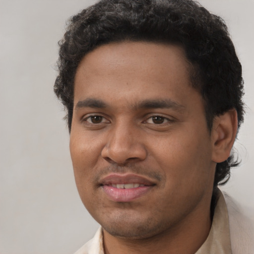 Joyful latino young-adult male with short  brown hair and brown eyes