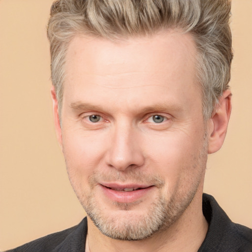 Joyful white adult male with short  brown hair and grey eyes