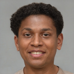 Joyful latino young-adult male with short  brown hair and brown eyes