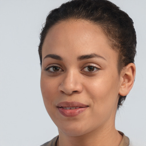 Joyful black young-adult female with short  brown hair and brown eyes