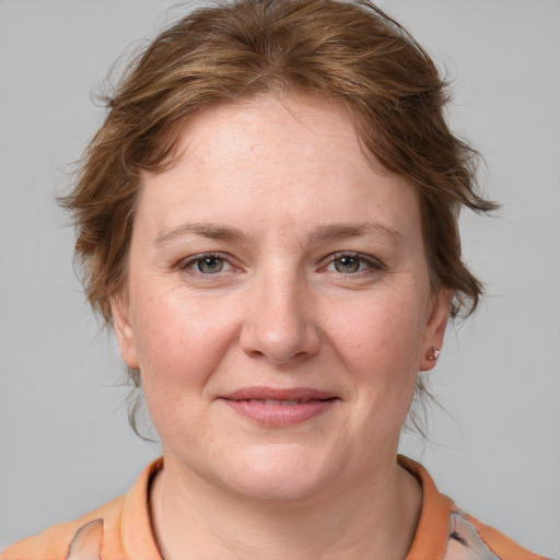 Joyful white adult female with medium  brown hair and grey eyes