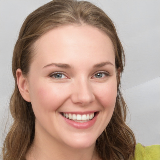 Joyful white young-adult female with long  brown hair and grey eyes