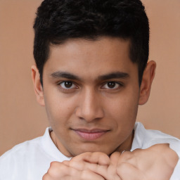 Joyful latino young-adult male with short  brown hair and brown eyes