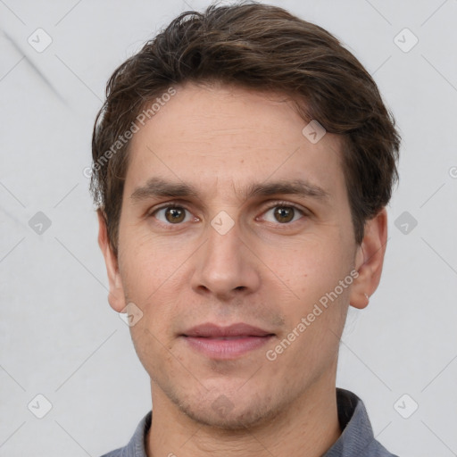 Joyful white adult male with short  brown hair and grey eyes