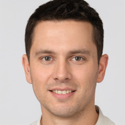 Joyful white young-adult male with short  brown hair and brown eyes