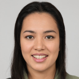 Joyful latino young-adult female with long  brown hair and brown eyes