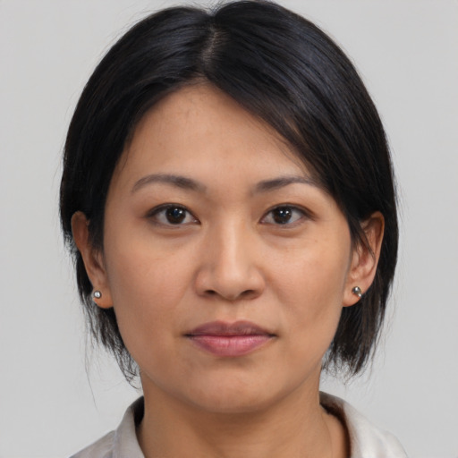 Joyful asian young-adult female with medium  black hair and brown eyes