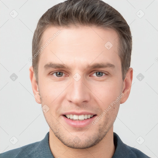 Joyful white young-adult male with short  brown hair and grey eyes