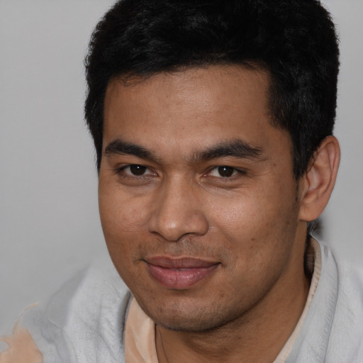 Joyful asian young-adult male with short  brown hair and brown eyes