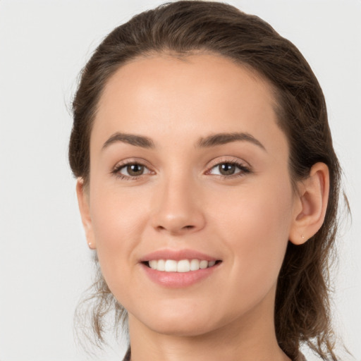 Joyful white young-adult female with medium  brown hair and grey eyes