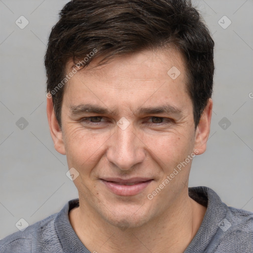 Joyful white adult male with short  brown hair and grey eyes