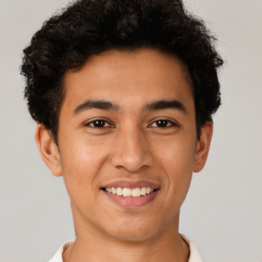 Joyful latino young-adult male with short  brown hair and brown eyes