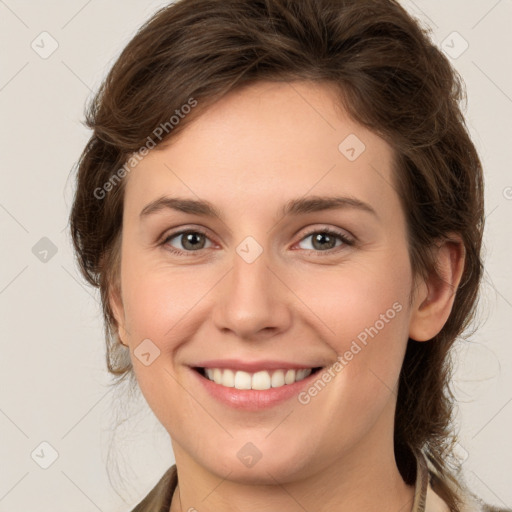 Joyful white young-adult female with medium  brown hair and grey eyes