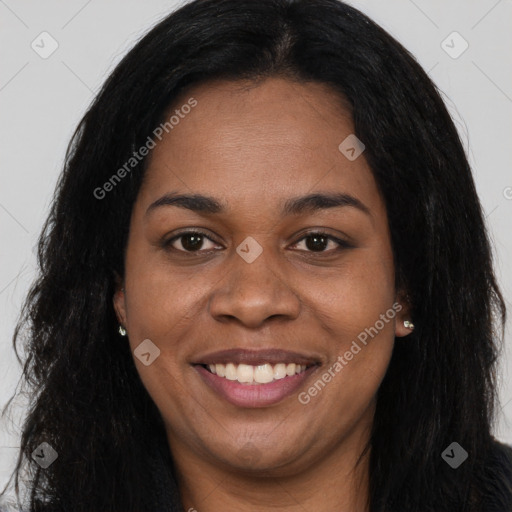 Joyful black young-adult female with long  black hair and brown eyes