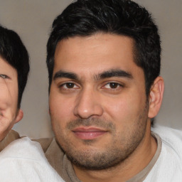 Joyful latino young-adult male with short  black hair and brown eyes