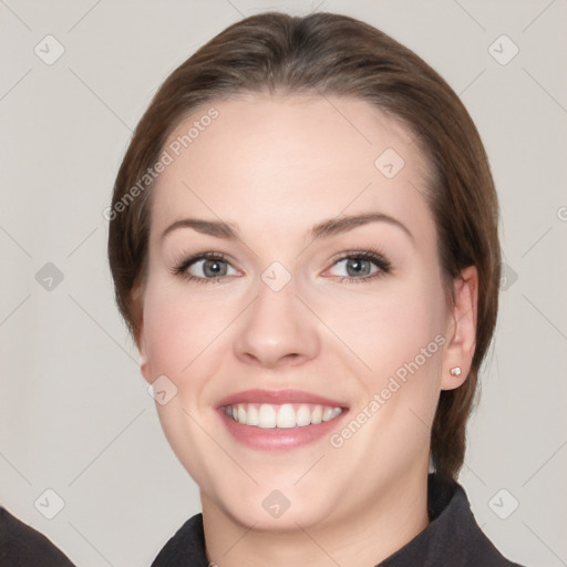 Joyful white young-adult female with medium  brown hair and grey eyes