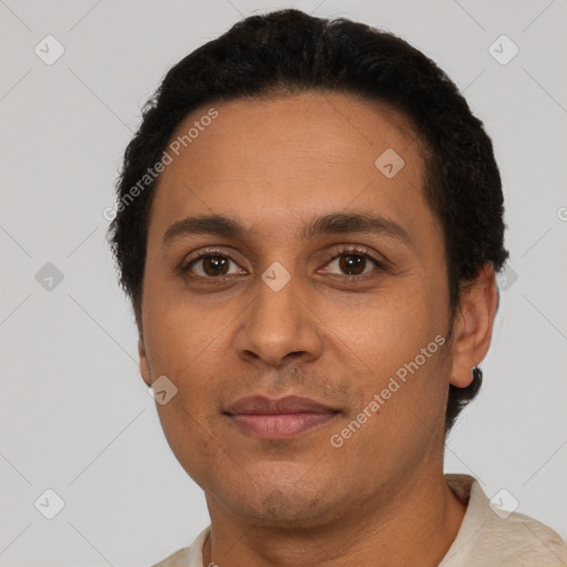 Joyful latino young-adult male with short  brown hair and brown eyes