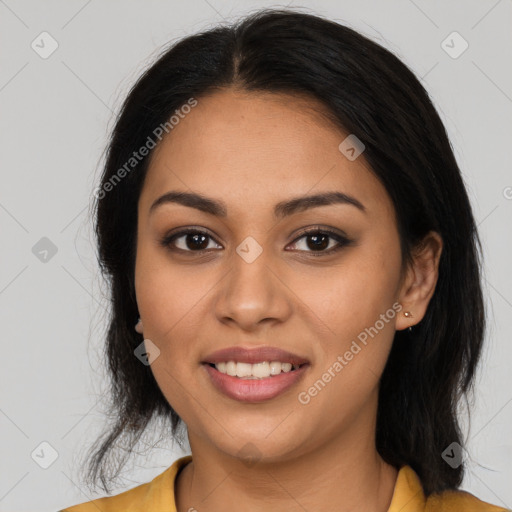 Joyful latino young-adult female with long  brown hair and brown eyes