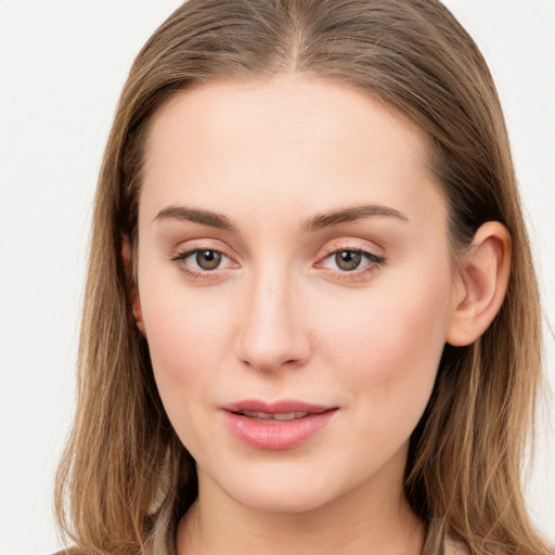 Joyful white young-adult female with long  brown hair and blue eyes