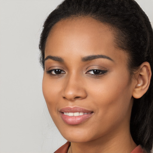 Joyful latino young-adult female with long  black hair and brown eyes