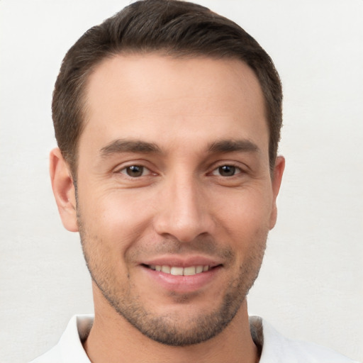 Joyful white young-adult male with short  brown hair and brown eyes