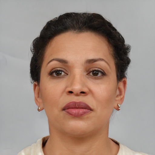 Joyful latino adult female with short  brown hair and brown eyes
