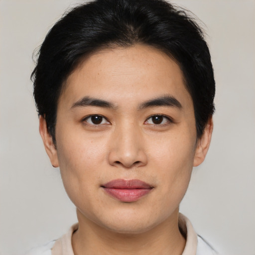 Joyful asian young-adult male with short  brown hair and brown eyes