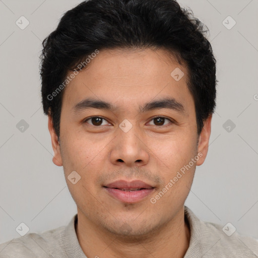 Joyful white young-adult male with short  black hair and brown eyes