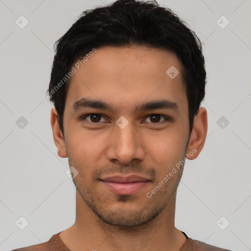 Joyful latino young-adult male with short  black hair and brown eyes