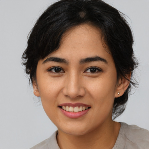 Joyful asian young-adult female with medium  brown hair and brown eyes