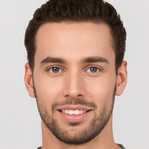 Joyful white young-adult male with short  brown hair and brown eyes