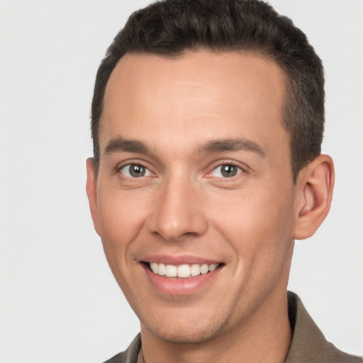 Joyful white young-adult male with short  brown hair and brown eyes